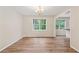 Elegant dining room with laminate floors, bright windows, and stylish chandelier at 4958 Alpine Ct, Winston, GA 30187