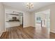 Open dining area with laminate flooring, chandelier, and seamless flow to the kitchen at 4958 Alpine Ct, Winston, GA 30187