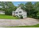 Spacious home with an attached garage and long driveway surrounded by lush greenery at 4958 Alpine Ct, Winston, GA 30187