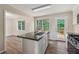 Well-lit kitchen featuring a central island, stainless steel sink, and access to an outdoor deck at 4958 Alpine Ct, Winston, GA 30187