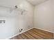 Functional laundry room area with hardwood floors, utility connections, and wire shelving at 4958 Alpine Ct, Winston, GA 30187
