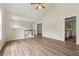 Open-concept living room with laminate flooring, leading to staircase and kitchen at 4958 Alpine Ct, Winston, GA 30187