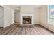 Cozy living room with stone fireplace and laminate flooring, brightened by natural light at 4958 Alpine Ct, Winston, GA 30187