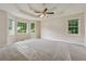 Spacious main bedroom with a tray ceiling, ceiling fan, and multiple windows at 4958 Alpine Ct, Winston, GA 30187