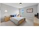 Neutral bedroom with a comfortable bed, a cozy lamp on nightstand, and a light wood dresser, ideal for relaxation at 506 Spring View Dr, Woodstock, GA 30188