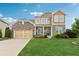 Charming two-story home with stone accents, a manicured lawn and a welcoming front porch at 506 Spring View Dr, Woodstock, GA 30188