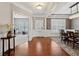 Elegant foyer with hardwood floors, wainscoting, and an open view to a dining room and office at 506 Spring View Dr, Woodstock, GA 30188