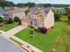Aerial view of a home with well-maintained landscaping, a lush lawn, and a spacious driveway at 506 Spring View Dr, Woodstock, GA 30188