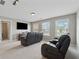 Bright living room features neutral walls, plush carpet, and comfortable seating area at 506 Spring View Dr, Woodstock, GA 30188