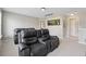 Modern living room with plush leather reclining seating, perfect for relaxing and watching movies at 506 Spring View Dr, Woodstock, GA 30188
