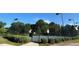 Tennis court surrounded by lush greenery, providing a private and scenic setting for sports enthusiasts at 506 Spring View Dr, Woodstock, GA 30188