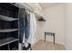 Compact walk-in closet, equipped with shelves and hanging space, perfect for organizing clothes and accessories at 506 Spring View Dr, Woodstock, GA 30188