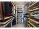 Spacious walk-in closet with custom shelving, drawers, and ample storage for clothes, shoes, and accessories at 506 Spring View Dr, Woodstock, GA 30188