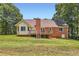 Beautiful exterior showcasing a well-maintained yard with a brick house and wooden deck at 11473 Summer Creek Dr, Hampton, GA 30228