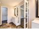 This bathroom features a vanity with glass doors to the main bedroom at 11473 Summer Creek Dr, Hampton, GA 30228