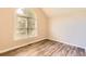 Bedroom features hardwood flooring, neutral walls, and a window that offers plenty of natural light at 11473 Summer Creek Dr, Hampton, GA 30228