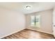 Bedroom features neutral walls, hardwood floor, natural light from the window at 11473 Summer Creek Dr, Hampton, GA 30228