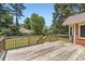 Spacious wooden deck ideal for outdoor lounging or entertaining with a view of the backyard at 11473 Summer Creek Dr, Hampton, GA 30228