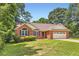 Charming brick home with a well-manicured lawn and attached two car garage at 11473 Summer Creek Dr, Hampton, GA 30228