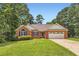 Charming brick home with a well-manicured lawn and attached two car garage at 11473 Summer Creek Dr, Hampton, GA 30228