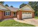 Charming brick home with a well-manicured lawn and attached two car garage at 11473 Summer Creek Dr, Hampton, GA 30228