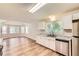 Well-lit kitchen with stainless appliances, granite counters, and wood floors at 11473 Summer Creek Dr, Hampton, GA 30228