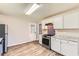 This kitchen features white cabinetry, stainless steel appliances and vinyl flooring at 11473 Summer Creek Dr, Hampton, GA 30228