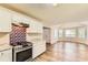 Stylish kitchen with stainless appliances, granite counters, and wood floors at 11473 Summer Creek Dr, Hampton, GA 30228