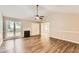 Bright living room featuring wood floors, a fireplace, and large windows at 11473 Summer Creek Dr, Hampton, GA 30228