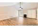 Bright living room featuring wood floors, a fireplace, and large windows at 11473 Summer Creek Dr, Hampton, GA 30228