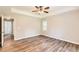 Main bedroom has tray ceiling, vinyl flooring, and door to ensuite bathroom at 11473 Summer Creek Dr, Hampton, GA 30228