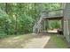 Wooded backyard showing the deck with stairs that lead down to a covered patio at 1223 Gathering Oaks Se Ct, Mableton, GA 30126