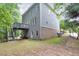 Exterior of the home showing the deck, brick foundation, and backyard at 1223 Gathering Oaks Se Ct, Mableton, GA 30126