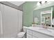 Well-lit bathroom features a shower with unique tile, white quartz counters, and ample storage space at 1223 Gathering Oaks Se Ct, Mableton, GA 30126