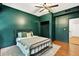 This bedroom features hardwood floors and a dark green accent wall at 1223 Gathering Oaks Se Ct, Mableton, GA 30126