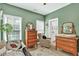 This bedroom features green walls, neutral carpet, and a plant near the window at 1223 Gathering Oaks Se Ct, Mableton, GA 30126
