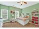 Cozy bedroom features a daybed with built-in storage, a ceiling fan, and natural light at 1223 Gathering Oaks Se Ct, Mableton, GA 30126