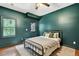This bedroom features hardwood floors and a dark green accent wall at 1223 Gathering Oaks Se Ct, Mableton, GA 30126