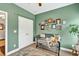 This bedroom features green walls, neutral carpet, and a black iron crib at 1223 Gathering Oaks Se Ct, Mableton, GA 30126