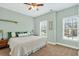 Bright bedroom with neutral colored walls, carpet, and two windows at 1223 Gathering Oaks Se Ct, Mableton, GA 30126