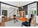 Elegant dining room featuring dark walls, wood table, and views of library and stairs at 1223 Gathering Oaks Se Ct, Mableton, GA 30126