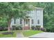 Beautiful home with manicured lawn, mature tree, inviting entryway with stairs and charming details at 1223 Gathering Oaks Se Ct, Mableton, GA 30126