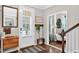 Bright foyer with hardwood floors, a decorative mirror, and a convenient bench upon entry at 1223 Gathering Oaks Se Ct, Mableton, GA 30126