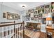 Bright hallway with hardwood floors, white railings, and a gallery wall filled with Gathering photos at 1223 Gathering Oaks Se Ct, Mableton, GA 30126