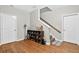 This hallway features two white doors, hardwood floors, and a staircase at 1223 Gathering Oaks Se Ct, Mableton, GA 30126