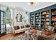 Comfortable living room with custom built-in bookcase, sofa, and ample natural light at 1223 Gathering Oaks Se Ct, Mableton, GA 30126