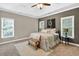 A spacious main bedroom features trey ceilings, neutral colors, and large windows for natural light at 1223 Gathering Oaks Se Ct, Mableton, GA 30126