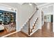 Elegant staircase with carpeted steps and wood railing, connecting the home's levels with style at 1223 Gathering Oaks Se Ct, Mableton, GA 30126