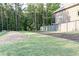 Expansive backyard with lush green lawn, privacy fence, and mature trees creating a peaceful oasis at 330 Carriage Glen Ln, Woodstock, GA 30188