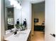 Modern bathroom with a large mirror, stylish vanity, and access to bedroom at 330 Carriage Glen Ln, Woodstock, GA 30188